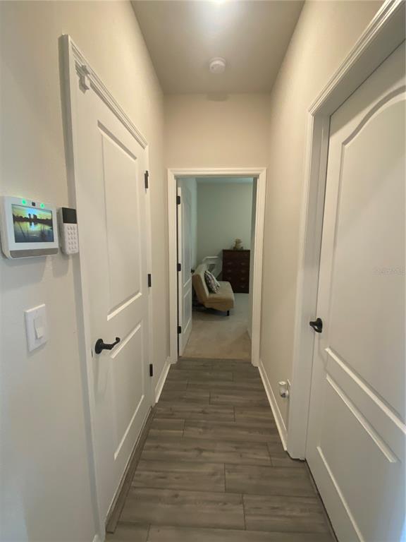9610 Rally Spring Loop Wesley Chapel, FL 33545 - Photo 9 of 38 a view of a hallway with wooden floor and closet