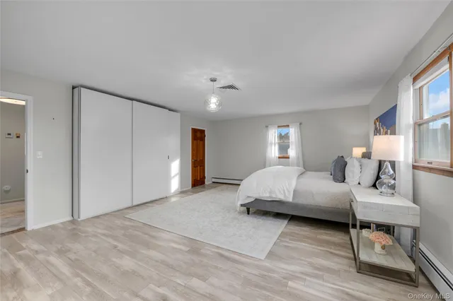 a spacious bedroom with a bed and a couch