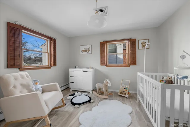 a living room with furniture and baby crib