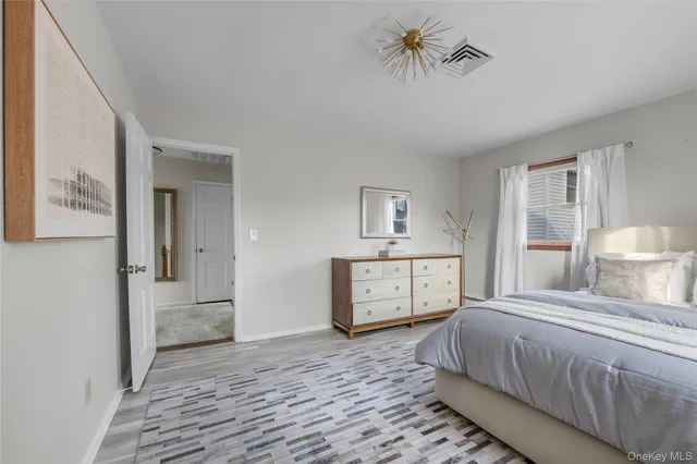 a bedroom with a large bed and a chandelier