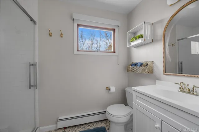 a bathroom with a granite countertop toilet and a sink