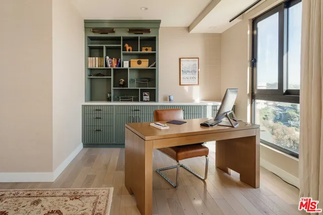 a bedroom with a bed flat screen tv and a large window