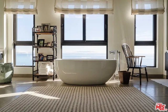 a large bathroom with a glass door shower and sink