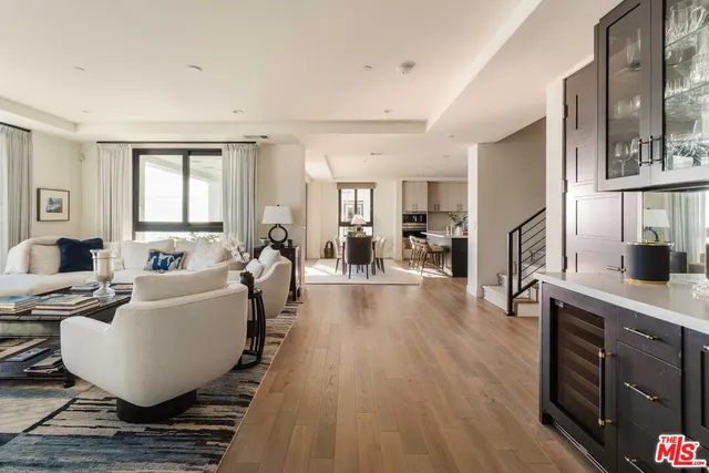 a living room with furniture a wooden floor and a window