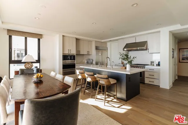 a kitchen with a sink cabinets and wooden floor