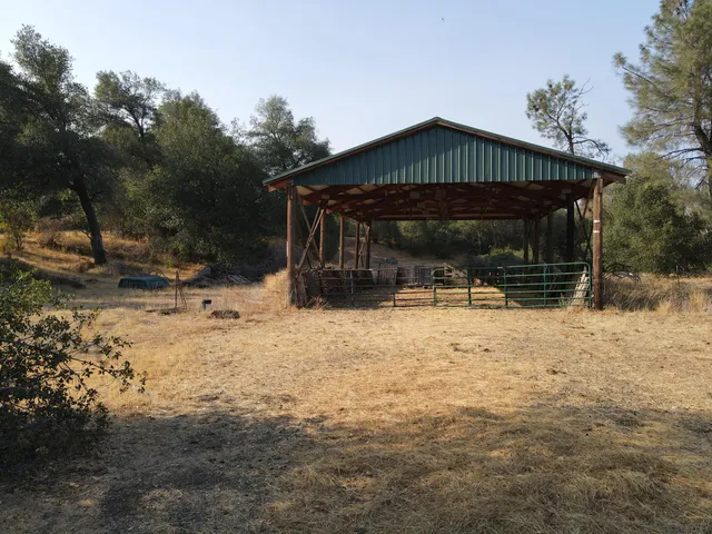 a view of a yard with table and chairs