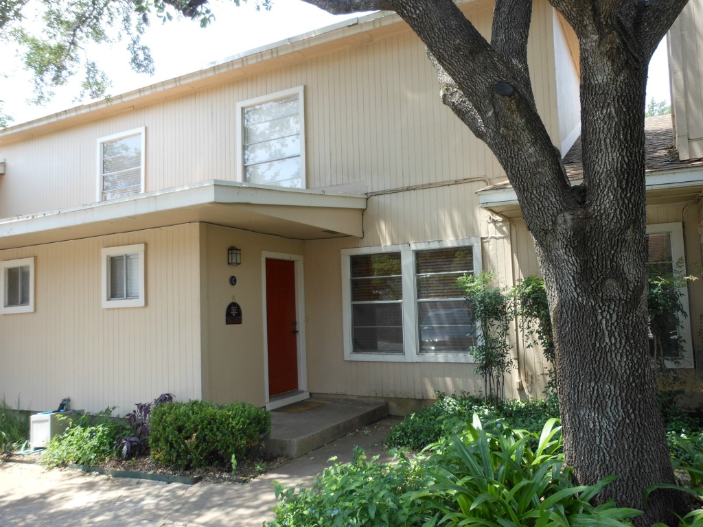 806 Castle Ridge Road, Unit C Austin, TX 78746 - Photo 1 of 1 a front view of a house with a yard