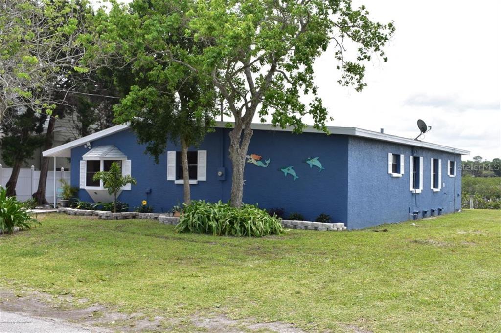 3004 Sunset Vista Drive Spring Hill, FL 34607 - Photo 1 of 1 a front view of house with yard and trees