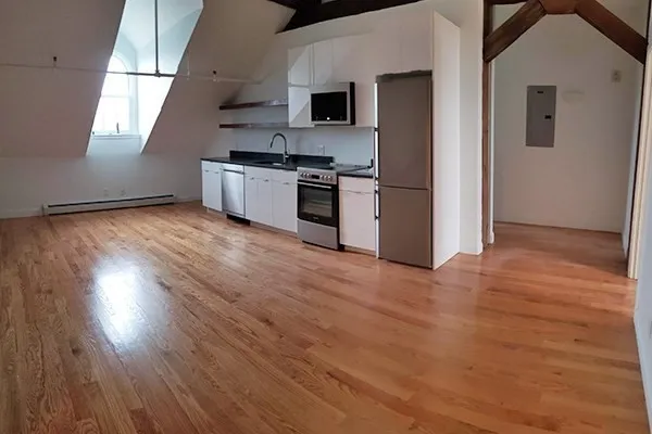 a kitchen with stainless steel appliances granite countertop a stove and a wooden floors