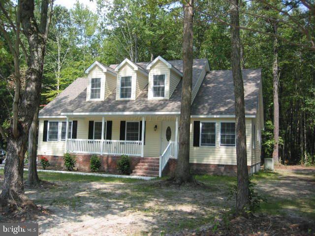 29490 Mt Vernon Road Princess Anne, MD 21853 - Photo 2 of 3 a front view of a house with a yard and trees