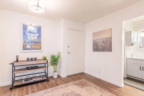 a view of a bedroom with furniture and wooden floor