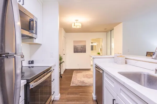 a kitchen with a sink stove and cabinets