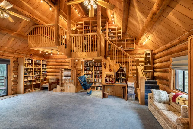 a bedroom with a bed next to a window