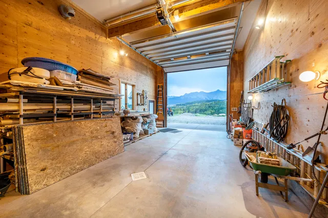 a bedroom with bed and a lamp on the wall