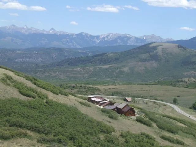 a view of a lush green hillside and a houses