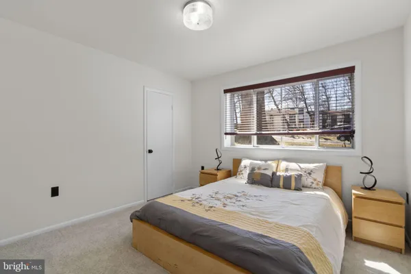a bedroom with a bed and window