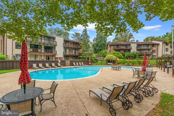 a view of a backyard with a patio and swimming pool
