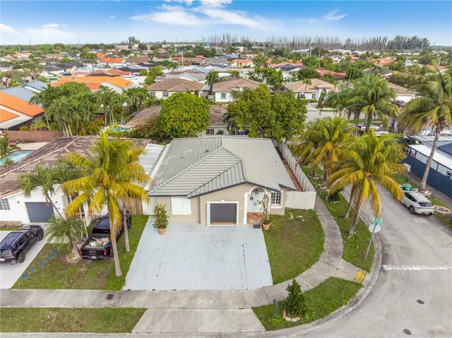 an aerial view of a house with a yard and lake view