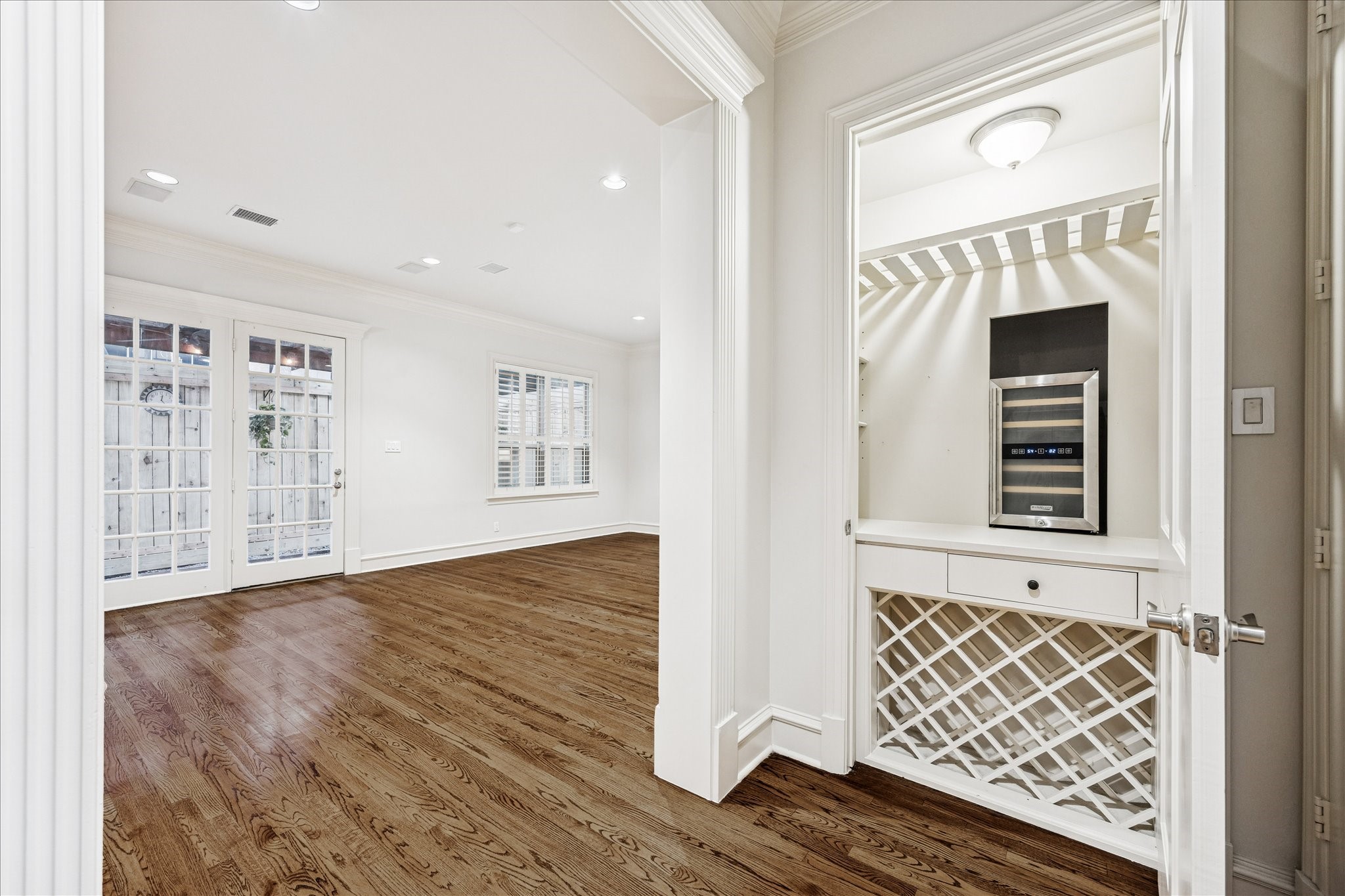 5823 Augusta Court Houston, TX 77057 - Photo 7 of 44 This bright, family room features elegant hardwood floors, French doors leading to an outdoor space, and a perfect spot for built-in wine rack with a cooler, ideal for entertaining.