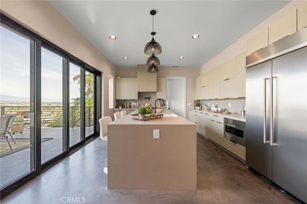 2380 Scenic Ridge Drive Chino Hills, CA 91709 - Photo 19 of 64 a kitchen with kitchen island a large counter top space and stainless steel appliances