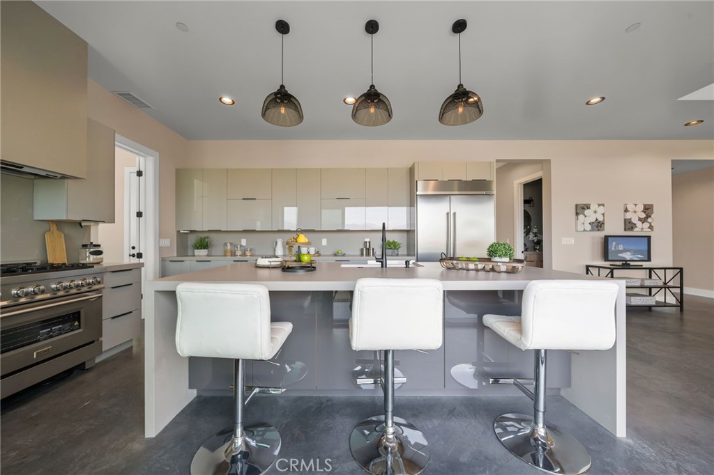 2380 Scenic Ridge Drive Chino Hills, CA 91709 - Photo 22 of 64 a kitchen with stainless steel appliances granite countertop a stove a sink a dining table and chairs with wooden floor