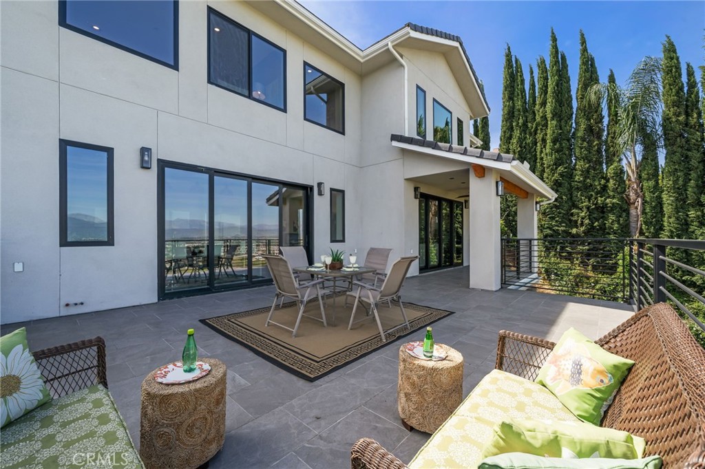 2380 Scenic Ridge Drive Chino Hills, CA 91709 - Photo 28 of 64 a view of a patio with couches table and chairs and potted plants