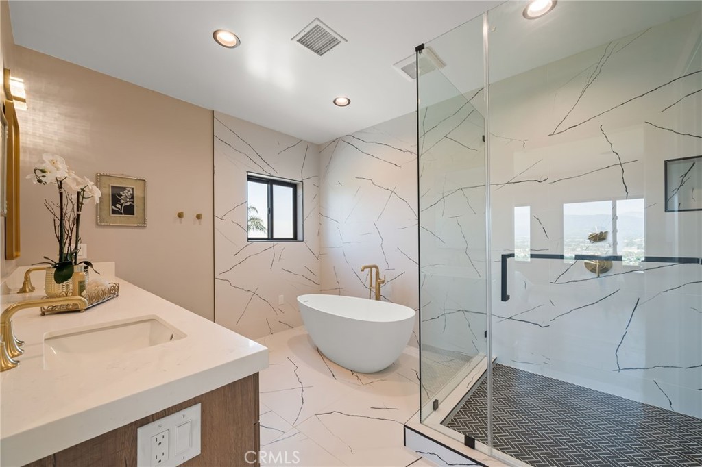 2380 Scenic Ridge Drive Chino Hills, CA 91709 - Photo 36 of 64 a bathroom with a double vanity sink a mirror and a bathtub