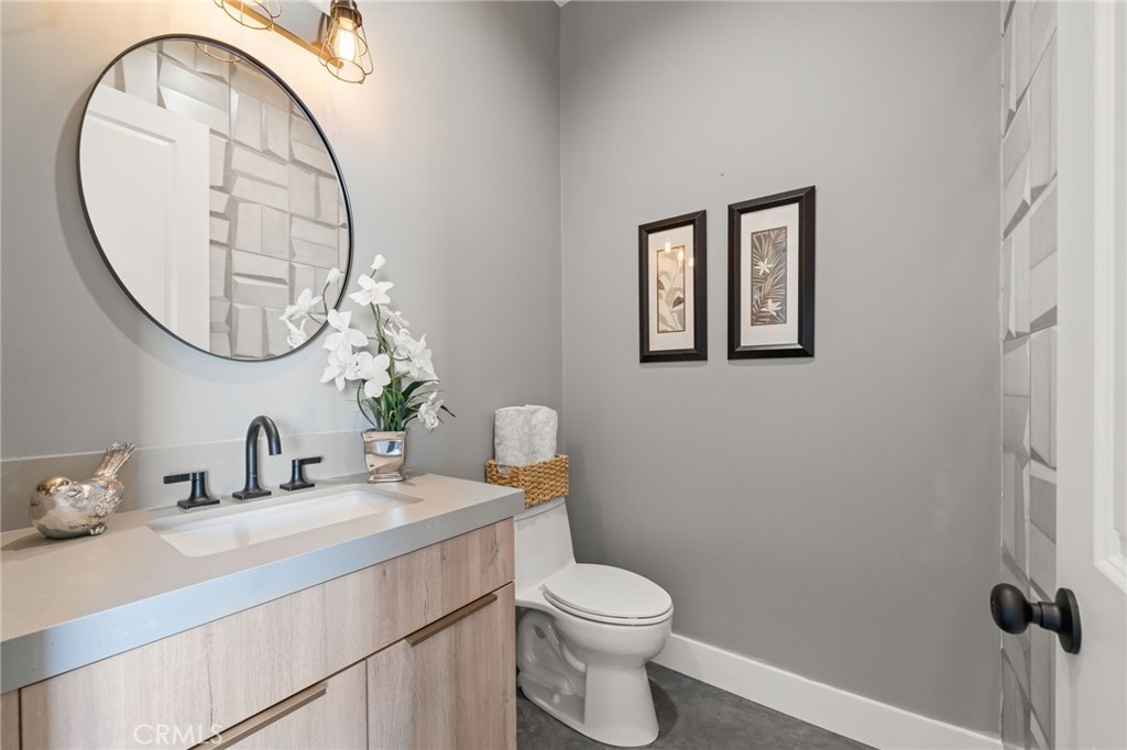 2380 Scenic Ridge Drive Chino Hills, CA 91709 - Photo 60 of 64 a bathroom with a toilet a sink and a mirror
