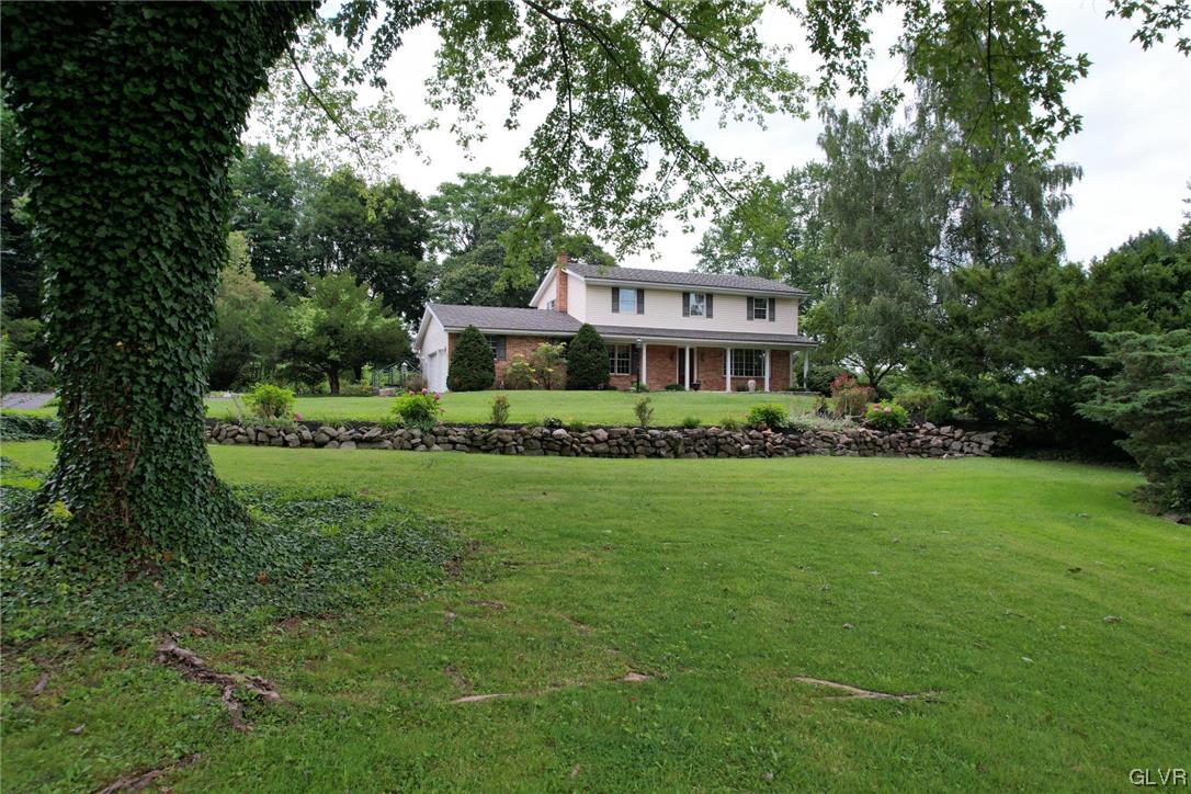 1145 Church Road Wind Gap, PA 18091 - Photo 1 of 24 a front view of a house with a garden and trees