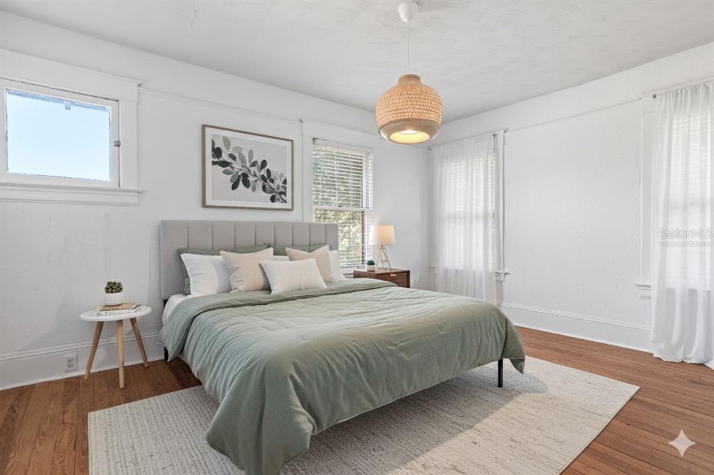 520 East Anderson Street Orlando, FL 32801 - Photo 12 of 26 a bedroom with a bed and wooden floor