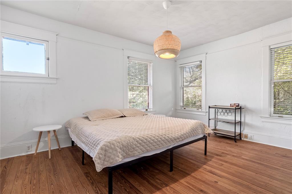 520 East Anderson Street Orlando, FL 32801 - Photo 13 of 26 a bedroom with a bed and wooden floor