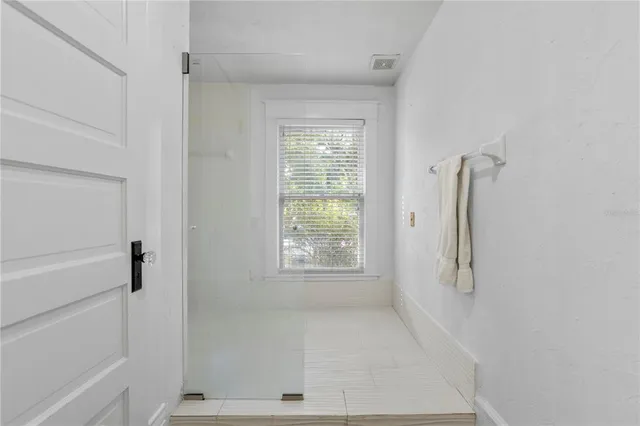 a view of an empty room with a window