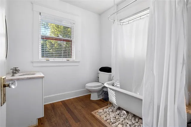 a bathroom with a toilet a sink and a window