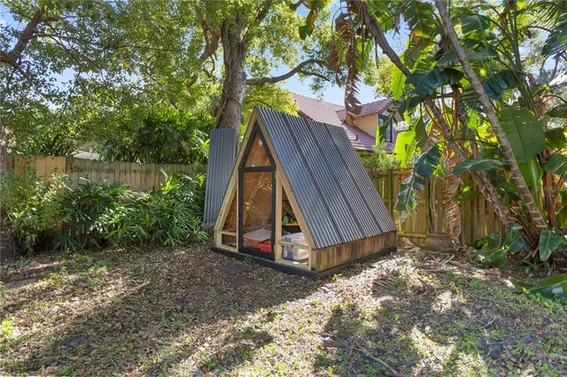 a view of a backyard with a small cabin