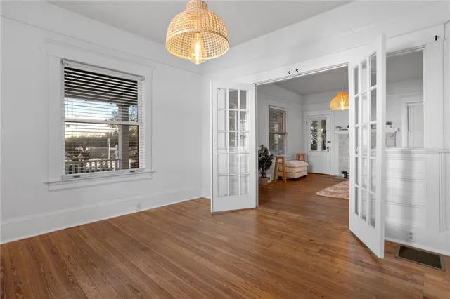 a view of a livingroom with wooden floor and a large window