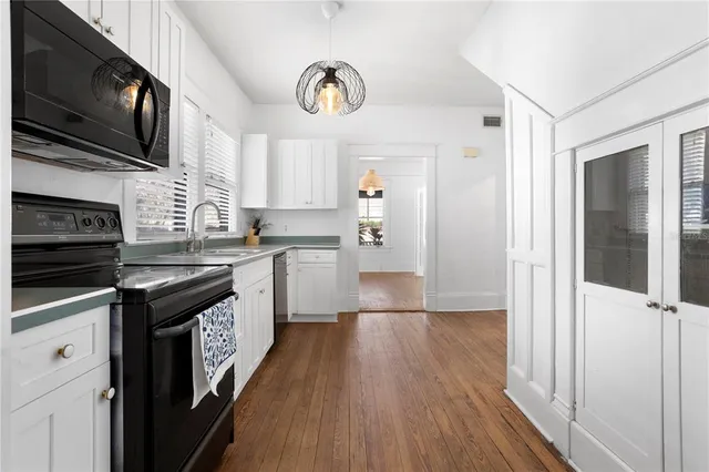 a kitchen with stainless steel appliances granite countertop a stove sink and cabinets