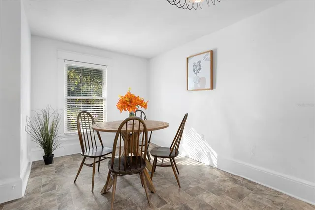 a view of a dining room with furniture and a potted plant
