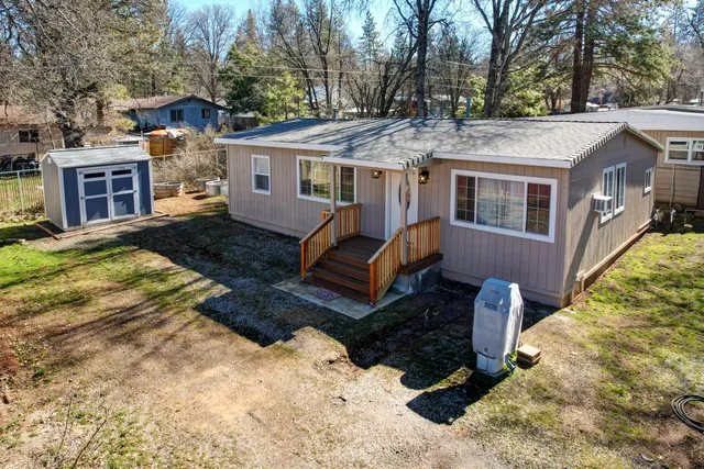 a front view of a house with a yard covered in snow