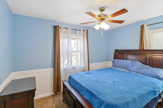 a bedroom with a bed and window