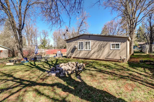 a view of a house with a yard covered in snow
