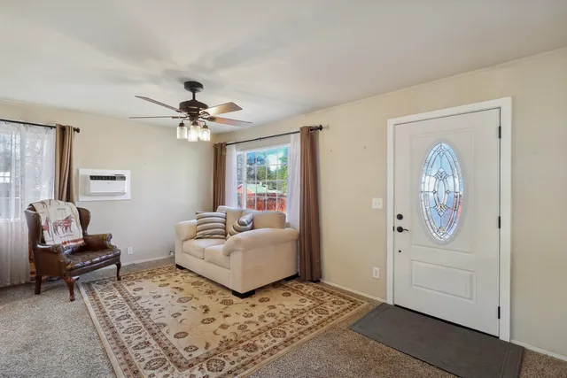 a living room with furniture and a chandelier