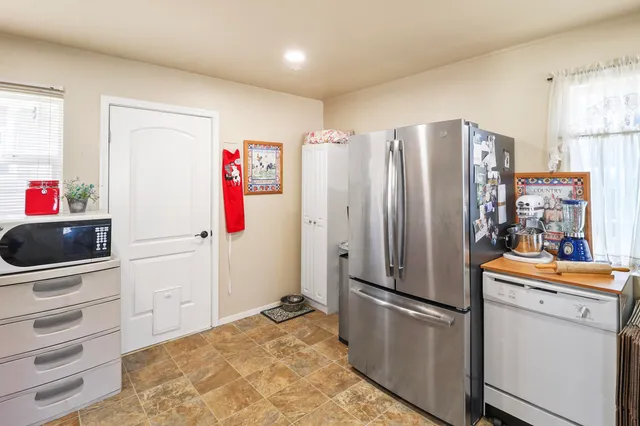 a kitchen with stainless steel appliances a refrigerator stove and cabinets