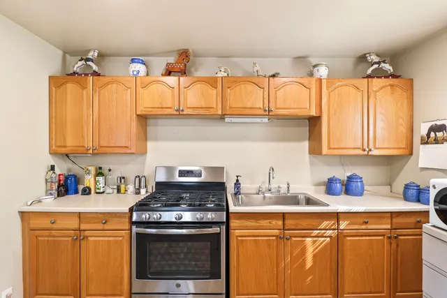 a kitchen with stainless steel appliances a stove a sink and cabinets