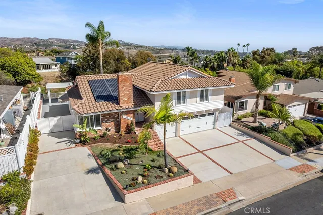 an aerial view of a house with garden space and street view