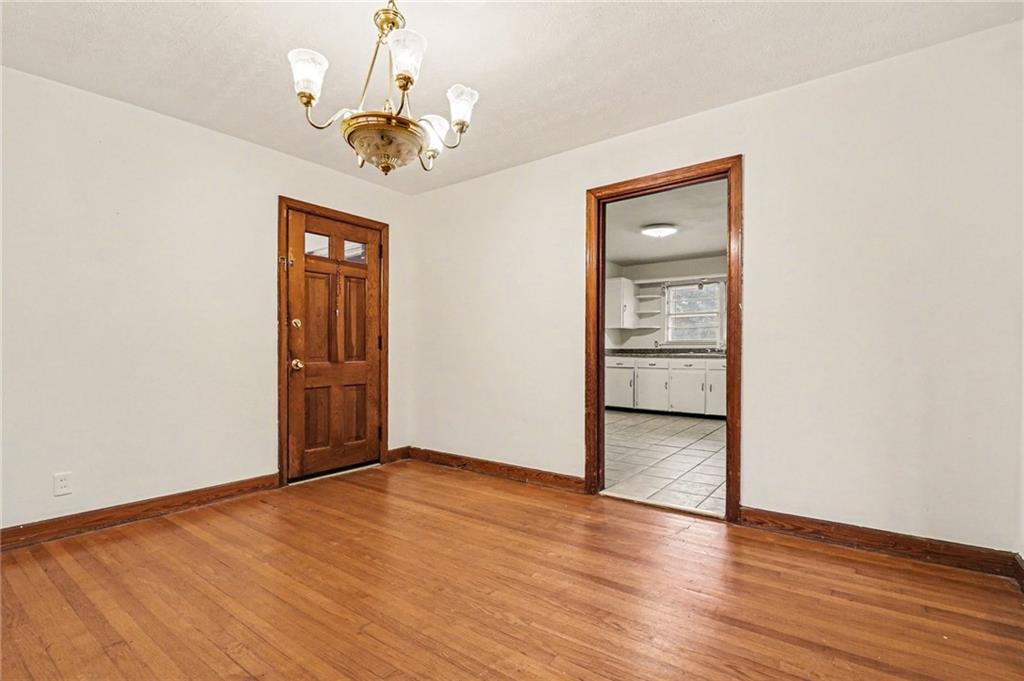 4568 Austell Powder Springs Road Southwest Austell, GA 30106 - Photo 5 of 15 a view of an empty room with wooden floor and a window