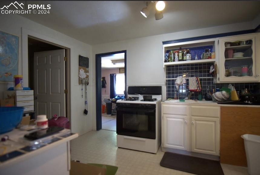 1015 Main Street Florence, CO 81226 - Photo 5 of 8 a kitchen with a stove and a refrigerator