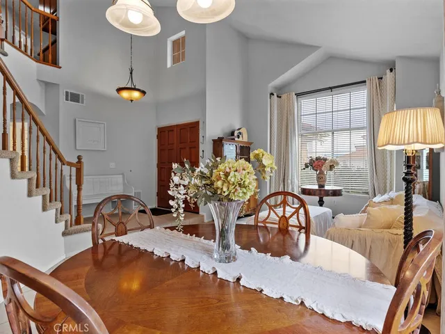 a living room with fireplace furniture and a chandelier