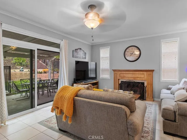 a living room with furniture a clock and a flat screen tv
