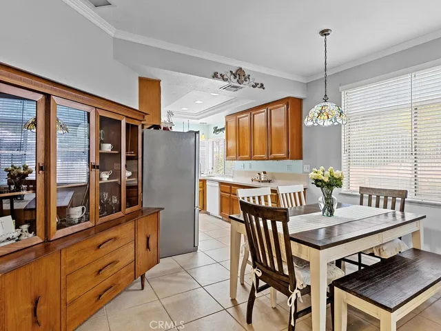 a kitchen with granite countertop a stove a sink and a refrigerator