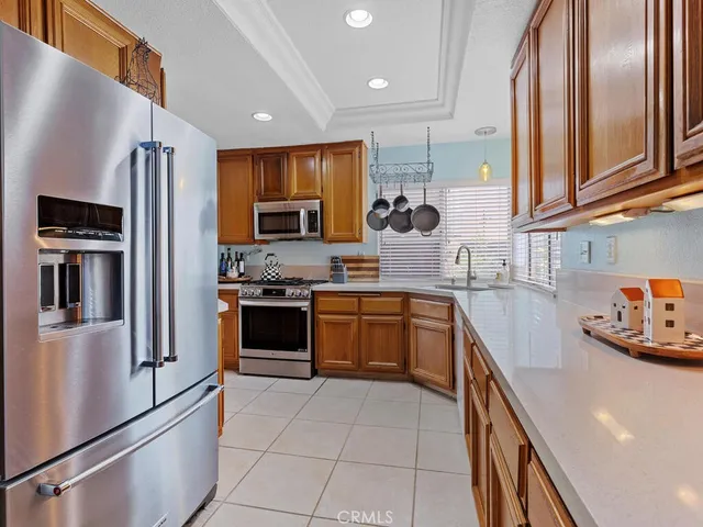 a kitchen with stainless steel appliances a refrigerator sink and microwave